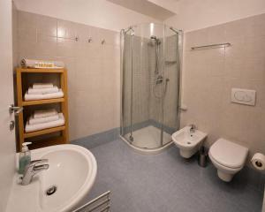 a bathroom with a shower and a sink and a toilet at Il rifugio in Trento +7 photos
