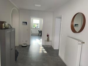 a hallway with white walls and a mirror on the wall at Moselglück in Pölich