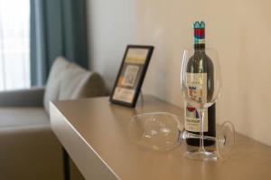 a bottle of wine sitting on top of a table at Corfelia Seaview Suites in Ipsos