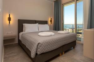a bedroom with a bed with two pillows on it at Corfelia Seaview Suites in Ipsos +25 photos