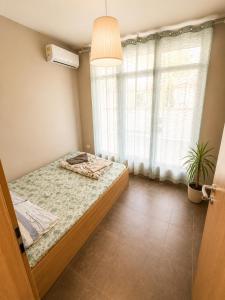 a bedroom with a bed and a window at Maxi 2 parking included in Sofia
