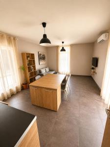 a living room with a table and a couch at Maxi 2 parking included in Sofia