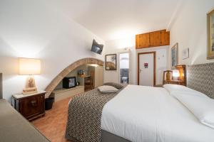 a bedroom with a white bed in a room at Affittacamere Valentina in Orvieto