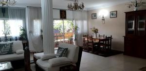 a living room with a couch and chairs and a table at Providence Guest house and Catering Services 01 in Abidjan