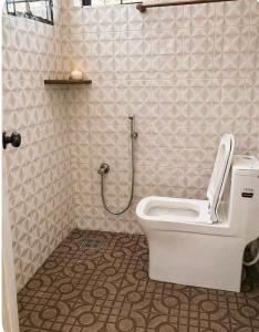 a bathroom with a toilet and a shower at Kandass Homestay in Trichūr