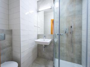 a bathroom with a shower and a sink and a toilet at HL Łebski Apartamenty in Łeba