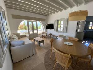 a living room with a table and a couch at Villa Palmosa in Skala +26 photos