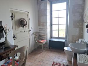 a bathroom with a sink and a toilet and a window at Chambre d'hotes de l'Ecu in Preuilly-sur-Claise +27 photos
