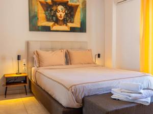 a bedroom with a bed with a painting on the wall at Bill Apartments in Patra