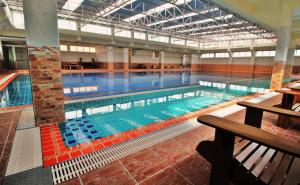 a large swimming pool in a large building at AC Sport Village in Bangkok +28 photos