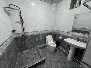 a bathroom with a toilet and a sink at ALAmir Khiva in Khiva +21 photos