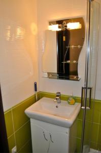 a bathroom with a white sink and a mirror at Apartment on Peace Avenue 84 in Mariupol