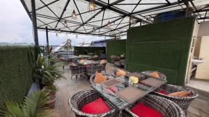 an outdoor patio with tables and chairs at Hotel Janmabhumi in Pashupatināth
