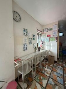 a room with chairs and a clock on the wall at Maria Kulafu Lodging House Pier site- Santa Clara office 2nd Floor in Cagba