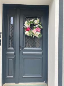 a blue door with a flower wreath on it at Chez Patou in Laval