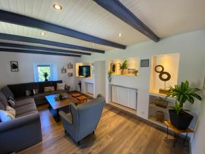 a living room with a couch and a table at Ardeche2coeur in Marcols-les-Eaux