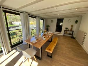 a dining room with a wooden table and chairs at Ardeche2coeur in Marcols-les-Eaux