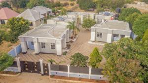 an overhead view of a white house with trees at Kamur Homes Apartment in Dodoma