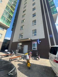 a motorcycle parked in front of a tall building at Sunrise Guesthouse UB in Ulaanbaatar