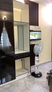 a room with a mirror and a hair dryer at Crystal Apartment in Ofada