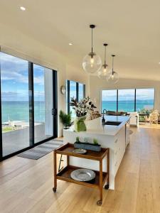 a living room with a view of the ocean at Coastal Luxe Villa in Kakanui