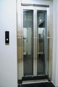 a set of glass elevators in a building at VS Residency in Elūru +10 photos