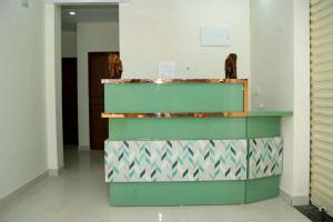a green counter in a room with a wall at VS Residency in Elūru