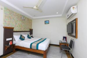 a hotel room with a bed and a tv at VS Residency in Elūru