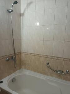 a bathroom with a tub and a shower with a shower at Къща за Гости ,,Afrikana,, in Sveti Vlas +15 photos