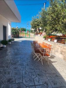 a table and chairs sitting on a stone patio at Villa Kena in Ksamil +10 photos