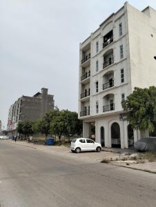 a white car parked in front of a building at 2 BHK Starry Night Penthouse in Islamabad