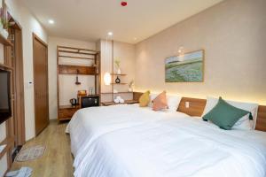 a bedroom with a large white bed in a room at MIRO Homestay in Hue +13 photos