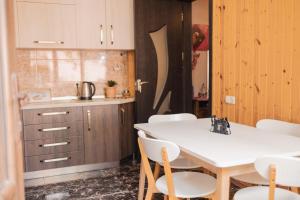 a kitchen with a white table and white chairs at Bethlehem Terrace in Tbilisi City +108 photos