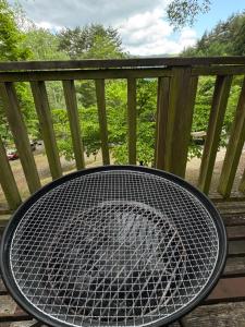 a table sitting on top of a deck at Cabin A MtFuji view, BBQ, lake Saiko 3mins, hammock, wood deck in Narusawa