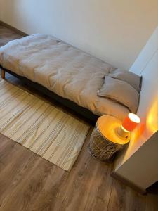 a bed sitting in a room with a table at Domino in Vaucouleurs
