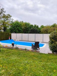 a swimming pool with a bench in a yard at Apfelhof Rüdersdorf in Rüdersdorf