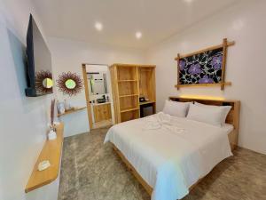 a bedroom with a large white bed in a room at Antuwanga reef resort in Moalboal