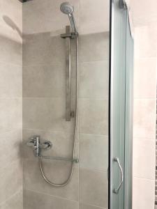 a shower with a glass door in a bathroom at Лана бугаз in Karolino-Buhaz