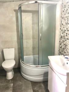 a bathroom with a shower and a toilet and a sink at Лана бугаз in Karolino-Buhaz