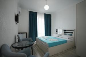 a bedroom with a bed and a table and chairs at Toma Palace in Makhinjauri +56 photos