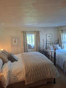 a bedroom with two beds and a window at Eastview Bed and Breakfast in Garrigill
