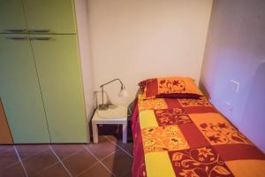 a bedroom with a bed and a lamp next to a door at Spacious 2BR with 2 Ensuite Baths in Florence in Florence