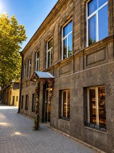 a brick building with a floral arch on a street at Mini hotel in centre in Yerevan