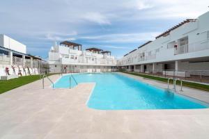 a large swimming pool in the middle of a building at Mojacar 1ª linea playa vacaciones in Mojácar