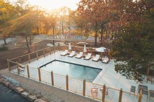 an overhead view of a pool with chairs and a fence at Glamping Tent, Hike, Smore Vibes in Branson