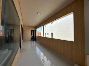 a hallway with a large window in a building at Motel Mỹ Linh 976 in Long Hai