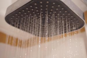 a shower with water dripping from a shower head at Residy Hideaway in Patong Beach +56 photos