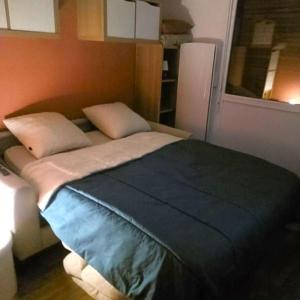 a bed with two pillows on it in a room at Appartement Vignec proche Saint-Lary in Vignec
