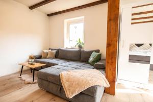 a living room with a couch and a table at Rhön & Relax Schwarze Berge - Garten in Wildflecken