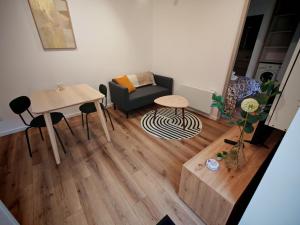 a living room with a couch and a table at Appartements à Evron in Évron